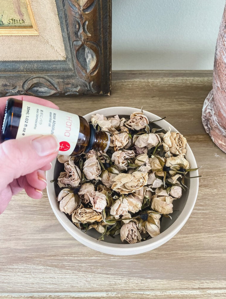 making potpourri with rose buds and rose oil