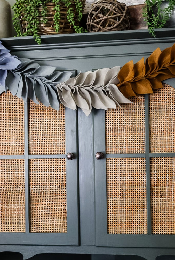 felt leaf garland hanging on cabinet