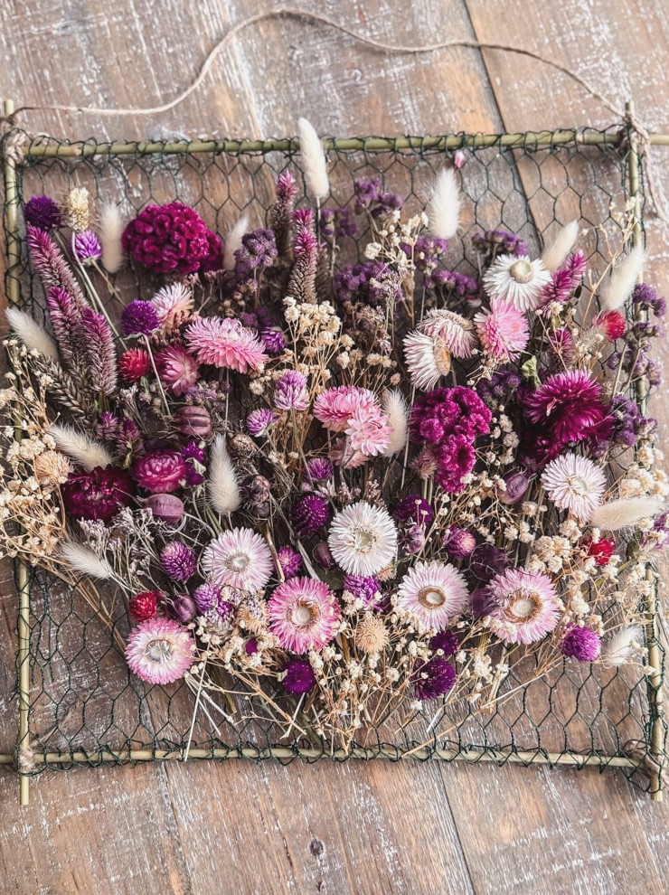 overhead photo of a frame filled with a dried flower bouquet