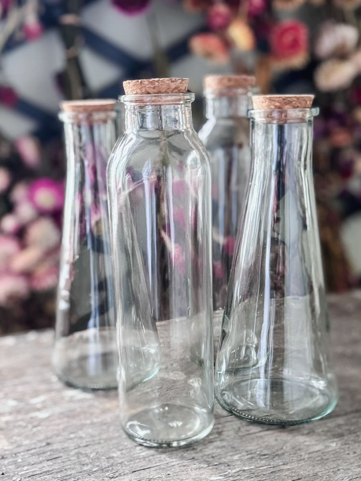 4 glass bottles with corks