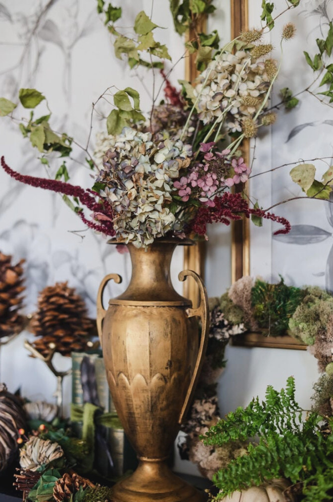 brass urn filled with dried flowers