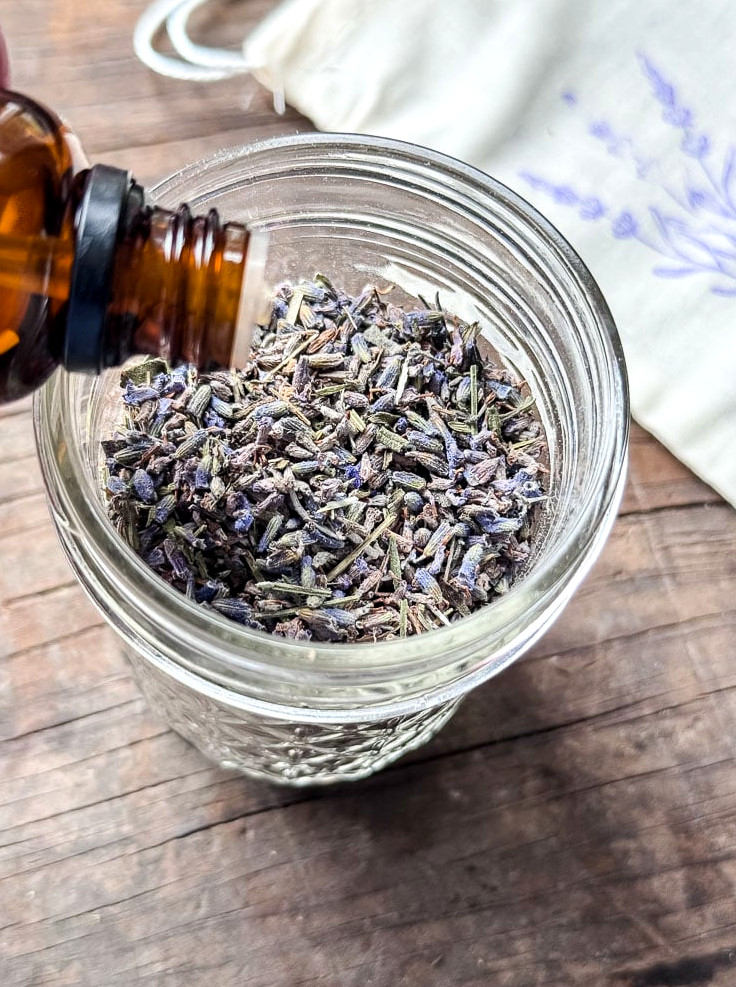 adding lavender oil to a jar of lavender