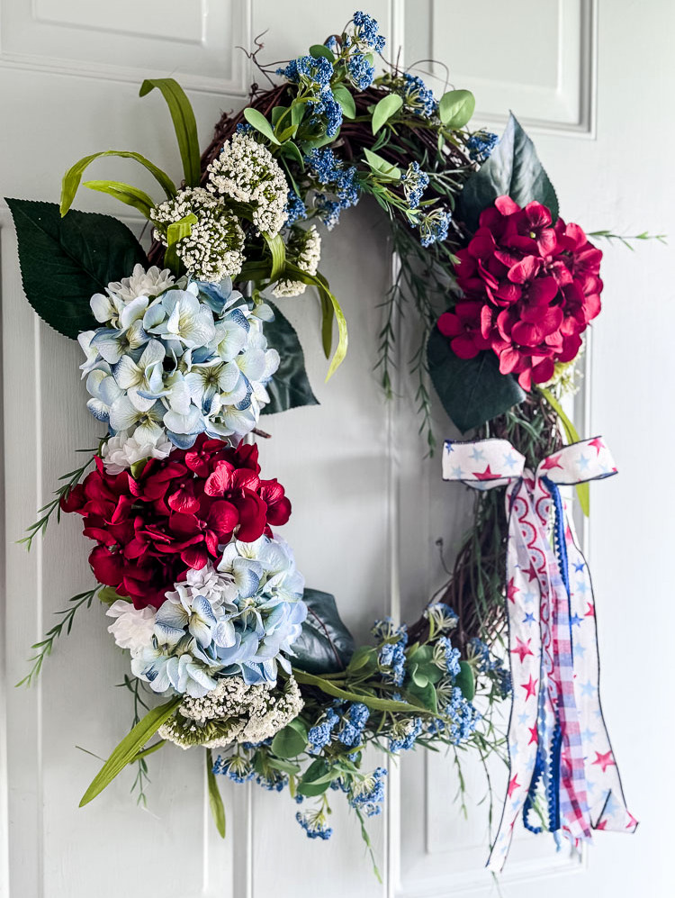 red,white,blue flower wreath on front door