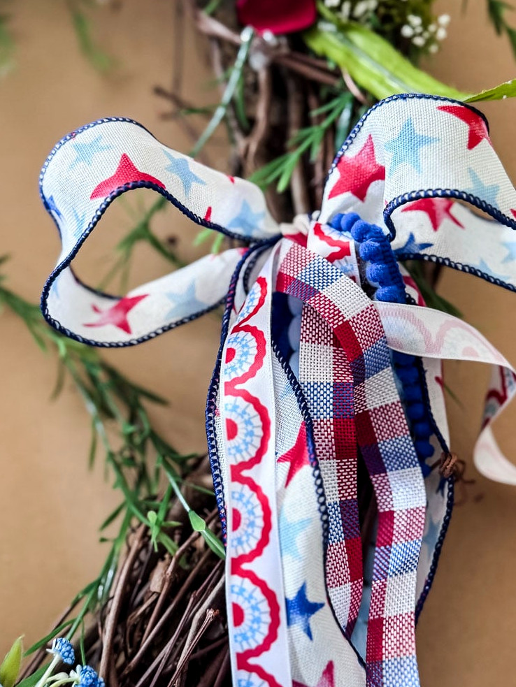 red,white, blue bow on a wreath