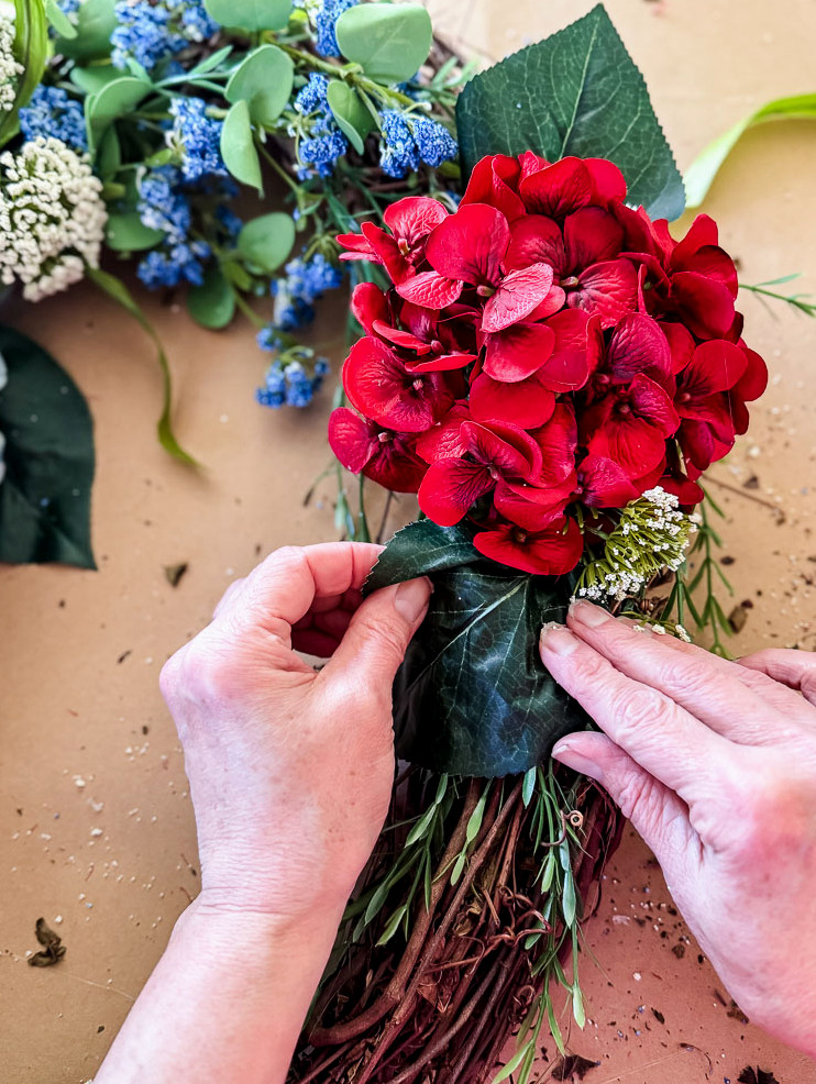 glueing a hydrangea to a wreath