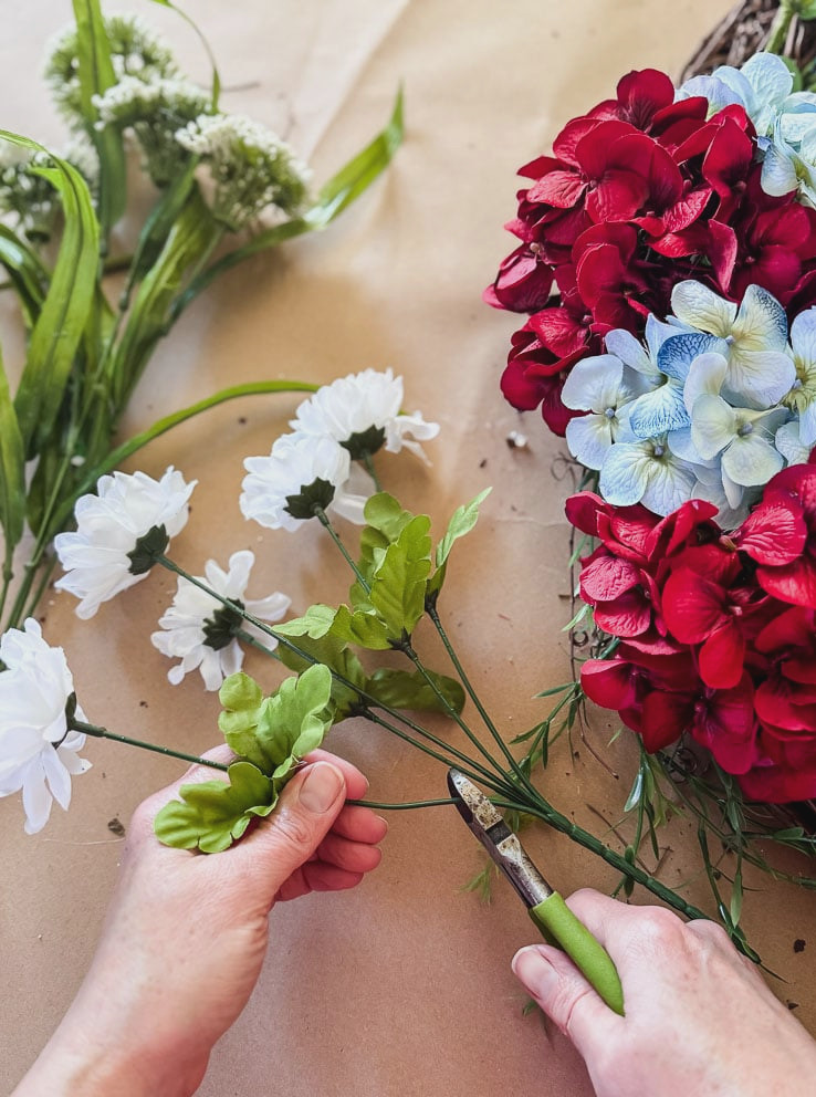 cutting fake flower stems with wire cutters