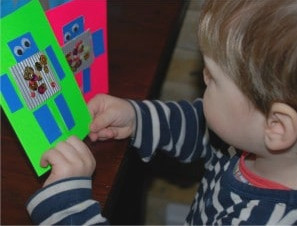 Toddler with homemade robot card for dad