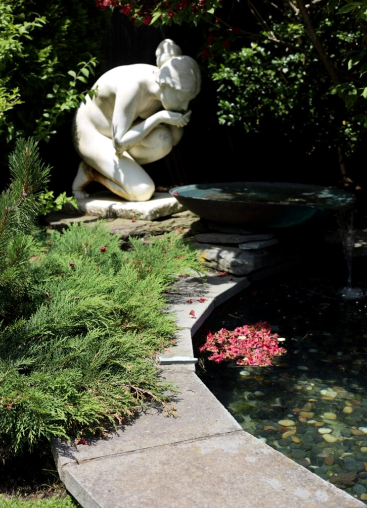 garden statue at a pond