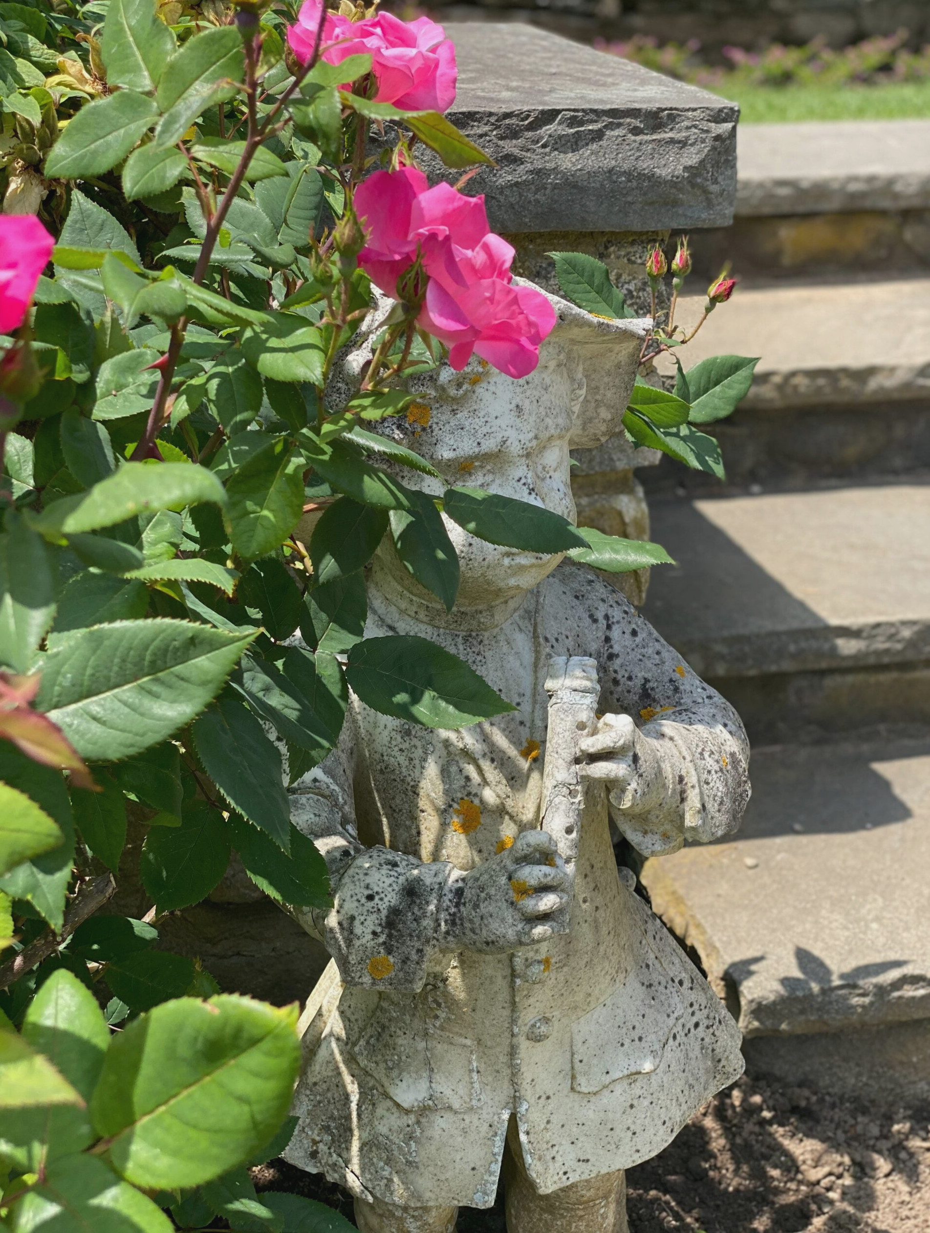 garden statue of boy playing flute