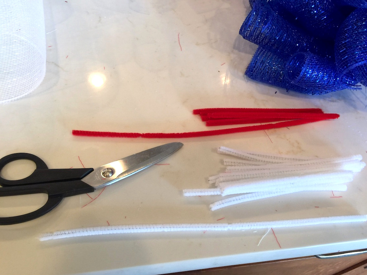Half-cut pipe cleaners beside a pair of scissors