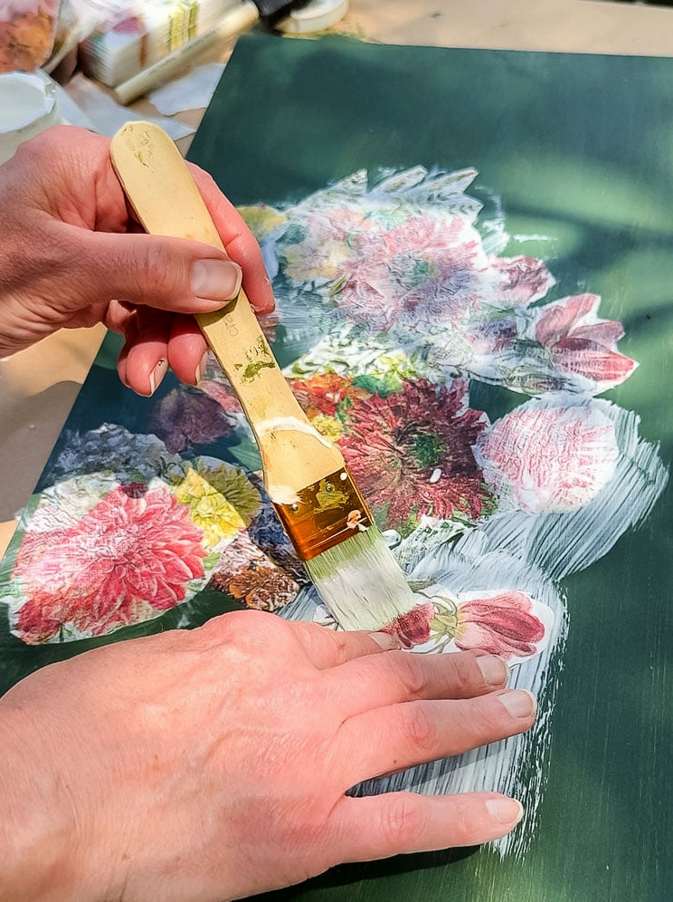 decoupaging flower napkon on green wood board
