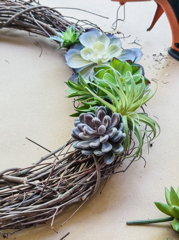 an artificial succulent wreath being made