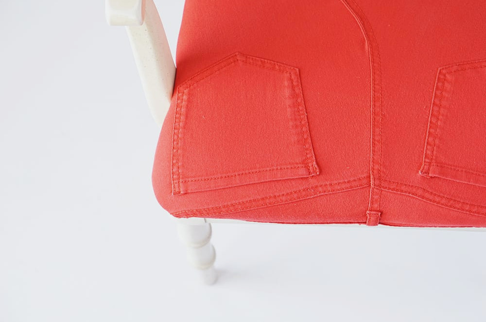 Detailed view of denim covering a chair seat
