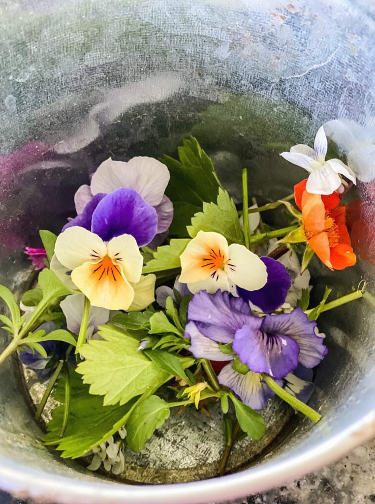 a container filled with spring flowers