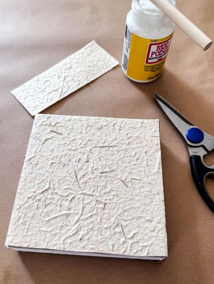 a book, scissors, and glue