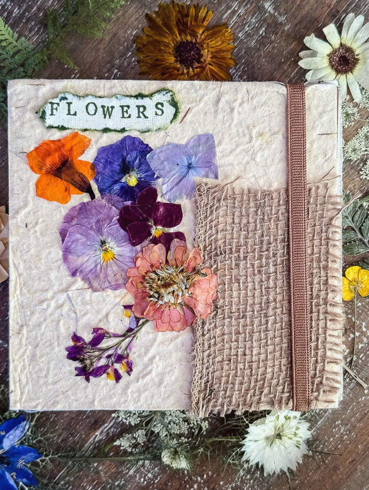 a journal cover with real pressed flowers glued to it