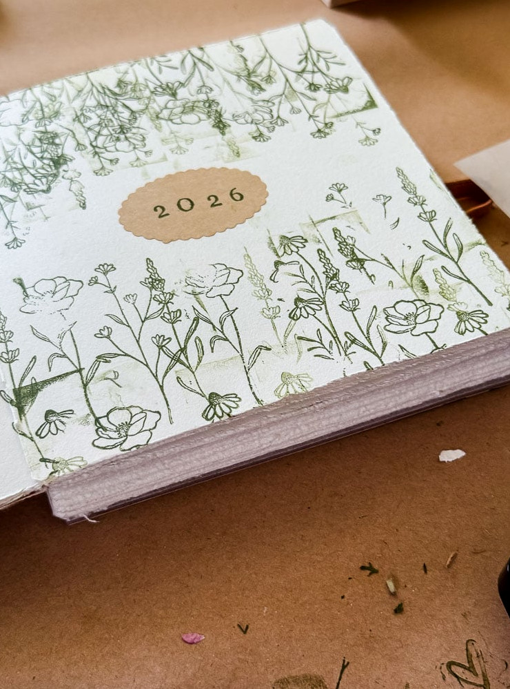 a page marked with 2026 and green stamped flowers embellishing the page