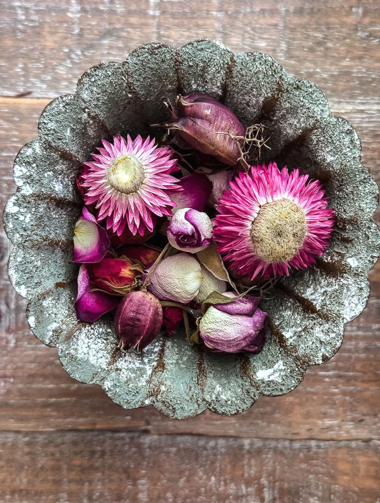 dried flowers in a metal decorative dish