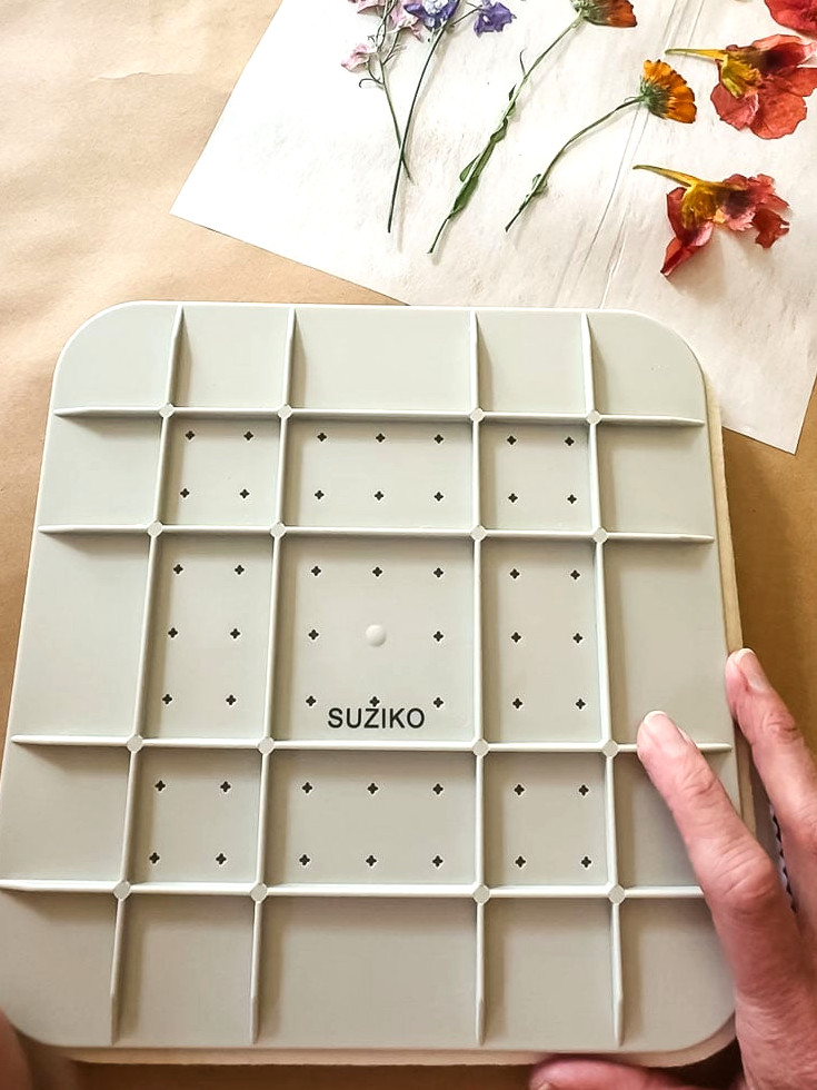microwave flower press with woman's hand touching top
